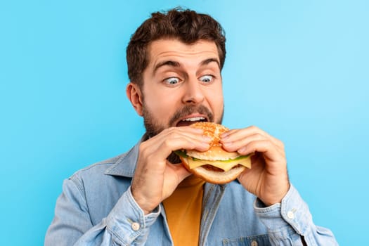 Closeup Portrait Of Funny Guy Eating Burger Enjoying Cheat Meal