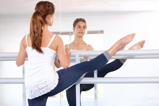 Stretching legs, ballet and girl on mirror in studio, barre and student exercise. Ballerina, young teenager and reflection for flexibility training, dance choreography for performance art and fitness