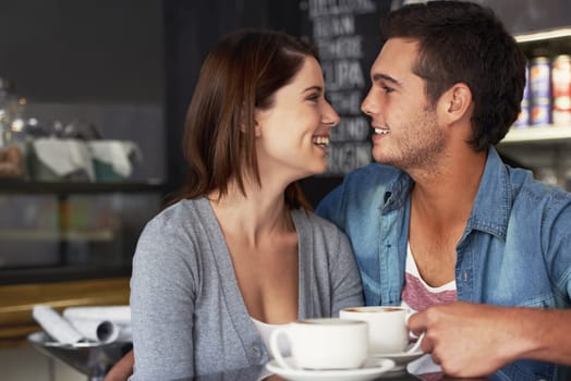 Smile, shop and couple drinking coffee in cafe, care and bonding together on valentines day date. Happy, man and woman in restaurant with latte for love connection, conversation and relationship