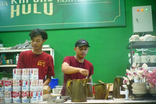 Baristas at the kopi tiam or Chinese Indonesian Coffee shop in Surabaya, Indonesia.