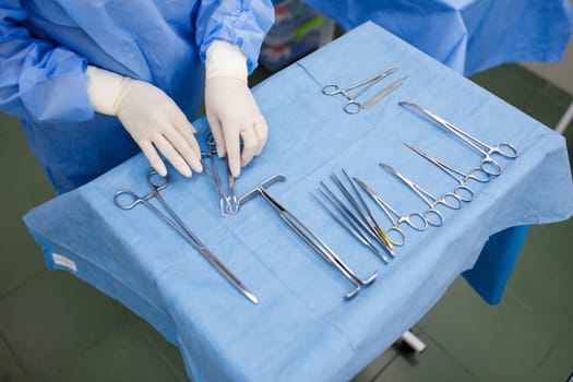 sterile instruments for surgery on the tray and hands
