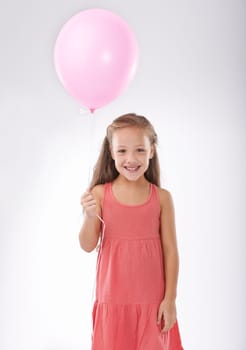 Girl, child and balloon in portrait, party or birthday with decoration for celebration, youth and happiness. Studio, young kid with toys and excited for anniversary with childhood on white background