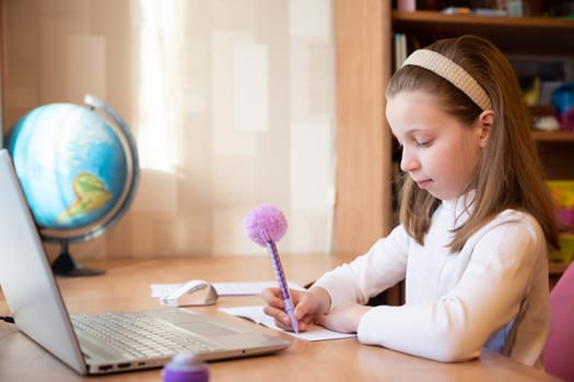 Online education of children. schoolgirl teaches a lesson online using a laptop video chat call conference with a teacher at home.pupil using conferencing on laptop with remote teacher, tutor.