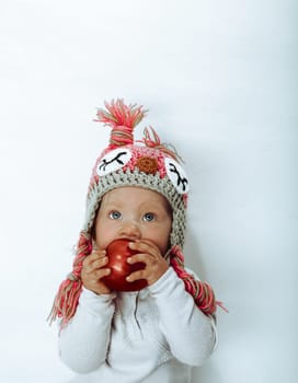 Baby girl eating a big apple