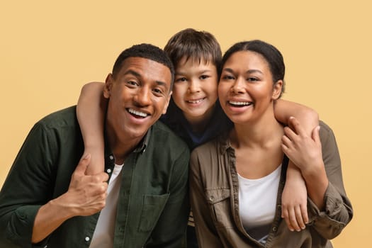 Closeup portrait of happy family hugging and smiling at camera