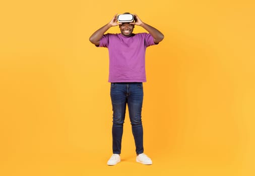 Full Length Shot Of Cheerful Black Man Wearing VR Headset