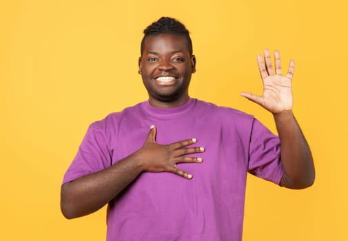 African guy swears raises his arm in oath gesture, studio