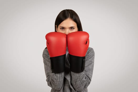 Determined woman with boxing gloves ready to fight