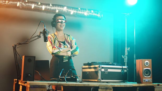 Woman disc jockey playing funky music on stereo turntables