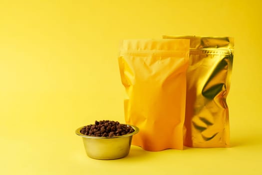 Cat food on yellow background studio shot