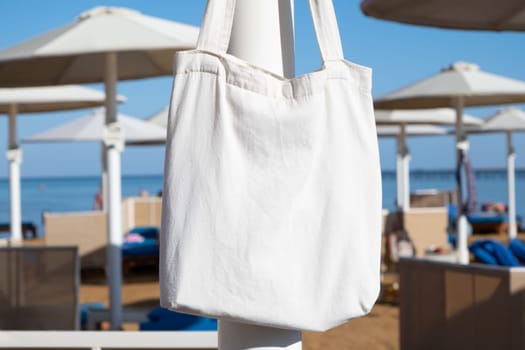 Mockup shopper handbag hanging on the beach
