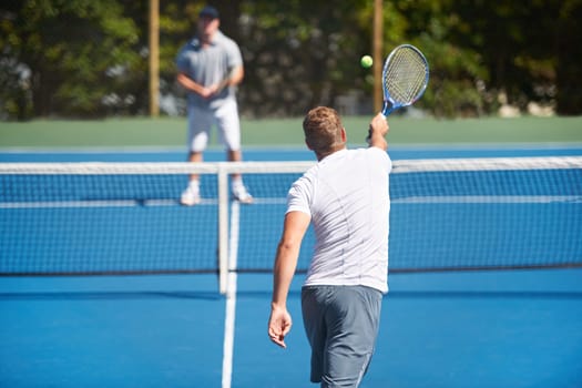 Tennis, game and men with fitness, friends and competition with training and exercise with a ball. Players, practice and guys with rackets and court with workout and sunshine with challenge or cardio