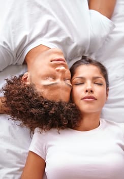 Sleeping, duvet and face of couple in bedroom for comfort, cozy nap and rest with eyes closed in Puerto Rico home. Bed, fatigue and top view of man, woman or people sleep with calm, peace or wellness