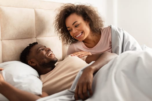 Closeup Shot Of Happy Black Spouses Cuddling Flirting In Bed