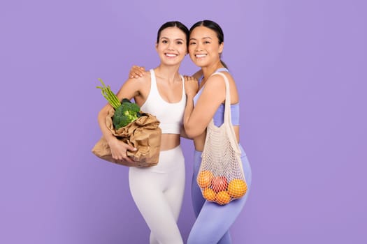 Female friends with organic groceries promoting healthy lifestyle choices