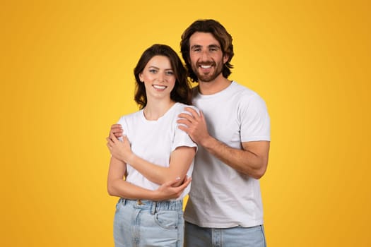 Happy young caucasian guy hug woman in white t-shirt, enjoy date, support and care
