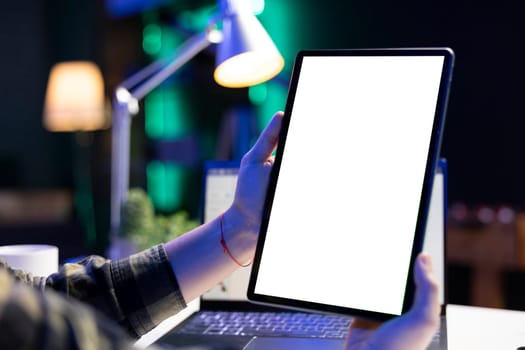 Individual holds tablet with white screen
