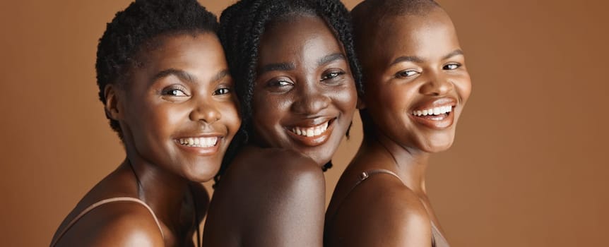 Face, beauty and laughing with black woman friends in studio on a brown background for natural wellness. Portrait, skincare and funny with a group of people looking happy at antiaging treatment