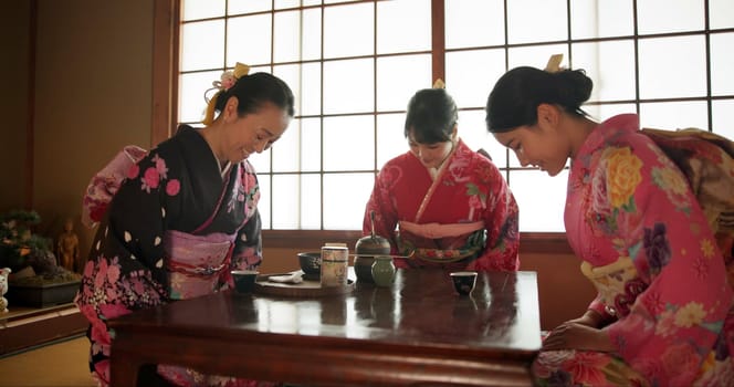 Japanese, women and bow for tea ceremony in Chashitsu room with kimono dress or custom tradition. People, temae and vintage style outfit or matcha for culture, fashion and happy with antique crockery
