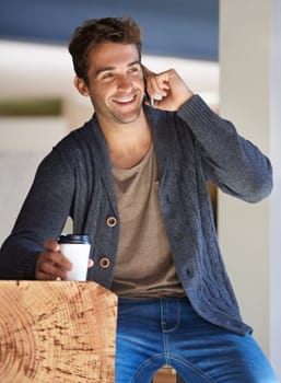 Phone call, smile and young man with coffee for deal, partnership or work communication in office. Happy, talking and male person on mobile conversation with cellphone and cappuccino in workplace