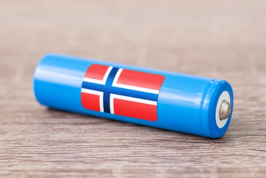 Rechargeable battery with flag of Norway on table