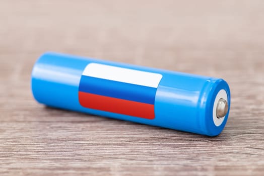 Rechargeable battery with flag of Russia on table