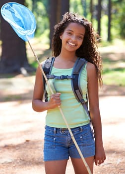 Girl, kid and butterfly net in forest for adventure and hiking outdoor, smile in portrait and backpacking. Travel, young explorer and happy in environment for trekking and explore nature for insects