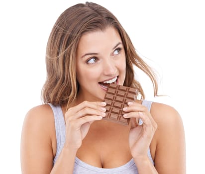 Woman, eating chocolate and love candy with mouth , pleasure and craving sugar in white background. Hungry, snack and meal for comfort, dessert and sweets for calories, diet and satisfaction