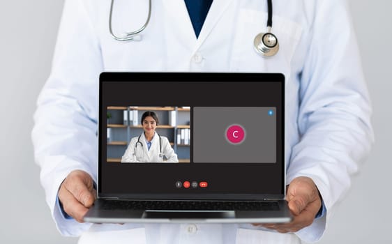 Cropped of man doctor showing laptop computer with video call