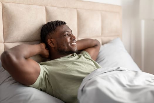 Black Guy Lying Awake Relaxing In Morning In Comfortable Bed