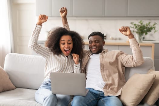 Joyful African American Couple With Laptop Gesturing Yes At Home