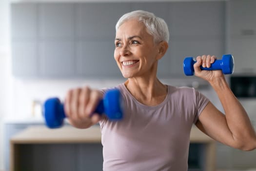 senior woman enjoys morning workout with weights in living room