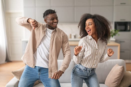 Positive Young African American Spouses Dancing Together At Home