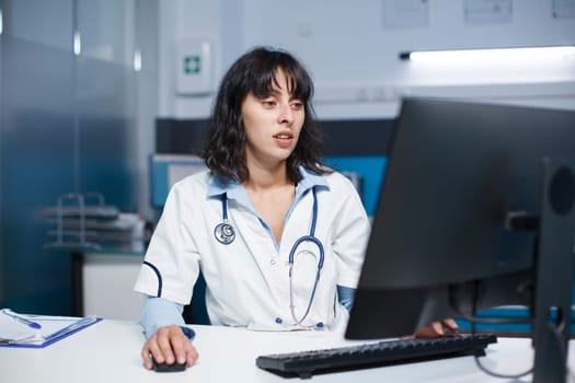 Female doctor using a desktop computer