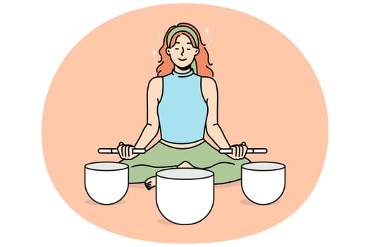 Calm woman meditate with singing bowls