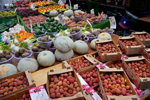 London, United Kingdom - February 04, 2019: Typical food market at Lewisham, Litchi, pumpkins and other vegetable / fruit displayed on street stall. It is usually sold in bowls, with same price tag