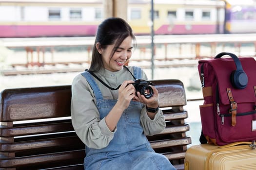 Young Asian woman backpack traveler using a camera. Journey trip lifestyle. travel concept
