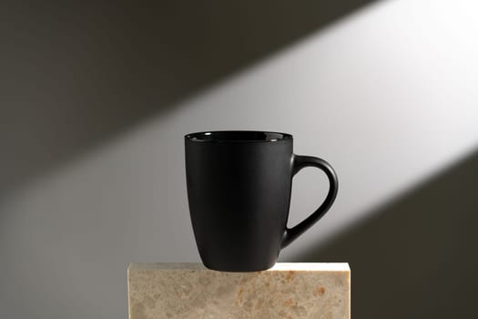 Black cup shadow sun light against gray background