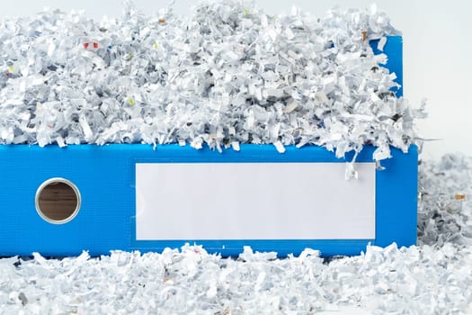 Paper folder and shredded paper in office