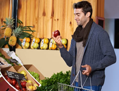 Apple, food or happy man shopping at a supermarket for grocery promotions, sale or discounts deal. Check, fresh or customer buying groceries for healthy nutrition, organic fruits or diet with choice