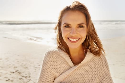 Travel, portrait and happy woman at a beach for summer, break or vacation, adventure or holiday. Ocean, face and female person smile at the sea with freedom, good mood or solo trip in South Africa