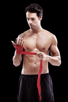 Man, hand wrap and fitness with boxer in a studio ready for boxing training and workout. Body, athlete and male fighter from Brazil with exercise, sport and wellness for battle with black background.