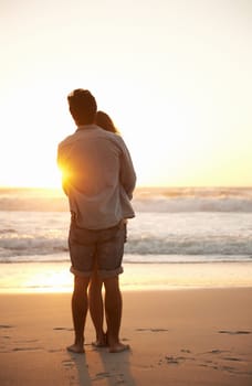 Man, woman and beach hug at sunset for summer travel or adventure, bonding or marriage. Happy couple, embrace and sea water for dating tourism or back view for nature vacation, environment or holiday