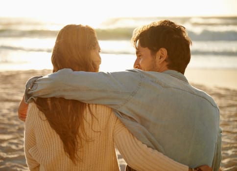 Beach hug, sunset and couple relax with summer sunshine, wellness and bonding on travel holiday in Greece. Embrace, marriage love and back of people connect with soulmate on anniversary or vacation