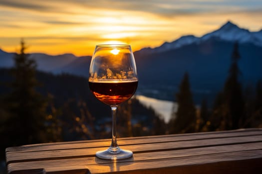 Glass of red wine and mountains on background