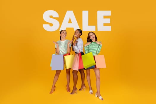 diverse women with shopping bags over background with word sale