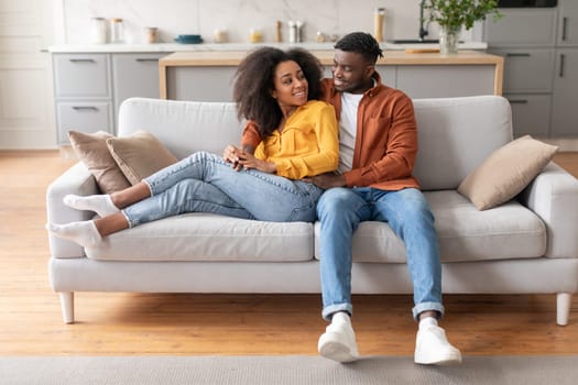 Lovely African American Young Spouses Hugging At Modern Living Room