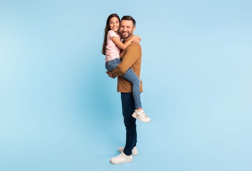 Daughter Embracing Dad As He Holds Her In Arms, Studio