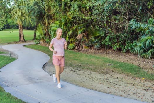 Active and determined, a pregnant woman maintains a healthy lifestyle, jogging with a focus on well-being and fitness during pregnancy