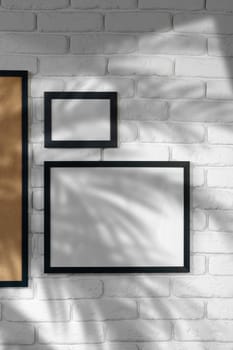 Black picture frame hanging on white brick wall copy space